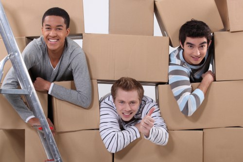 Removal team handling furniture in a local Osterley home