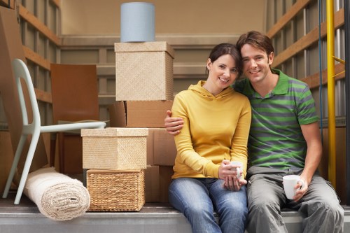 Professional movers loading furniture into a van in Osterley