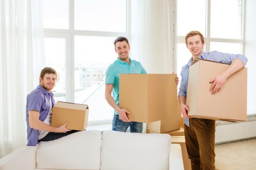 Removal specialists handling boxes and furniture during an Osterley move