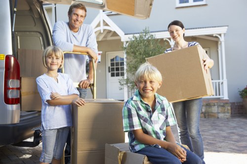 Boxes and furniture being unloaded into a new home
